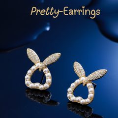 Elaro Spark Studs — Gold CZ Wing & Pearl Halo Earrings